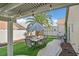 Covered patio featuring outdoor seating and a view of the landscaped yard at 688 Quiet Stream Ct, Henderson, NV 89052