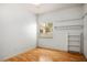 Well-lit bedroom with wood floors, a window with blinds, and closet space at 726 Sea Pines Ln, Las Vegas, NV 89107