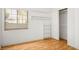 Bedroom with a large window for natural light, laminate floors, and closet space at 726 Sea Pines Ln, Las Vegas, NV 89107