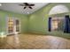 Open living room with tile floors, a ceiling fan, and French doors to the backyard at 726 Sea Pines Ln, Las Vegas, NV 89107