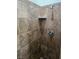 Bathroom shower featuring tiled walls, a chrome shower head, and a built-in shelf at 726 Sea Pines Ln, Las Vegas, NV 89107