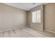 Neutral bedroom featuring wood-look floors and a window for natural light at 7530 Brisa Del Mar Ave, Las Vegas, NV 89179