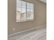 Bedroom featuring window with exterior view and wood-look floors at 7530 Brisa Del Mar Ave, Las Vegas, NV 89179
