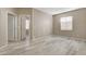 Bright bedroom features wood-style flooring, fresh paint, and a doorway leading to a walk-in closet at 7530 Brisa Del Mar Ave, Las Vegas, NV 89179