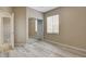 Neutral bedroom featuring wood-look floors, a window for natural light, and a mirrored closet at 7530 Brisa Del Mar Ave, Las Vegas, NV 89179