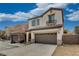 Two-story stucco home boasting a tile roof, green shutters, and a two car garage at 7530 Brisa Del Mar Ave, Las Vegas, NV 89179