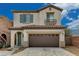 Two-story stucco home with a brown tiled roof, brown garage door, and a small balcony at 7530 Brisa Del Mar Ave, Las Vegas, NV 89179