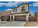 Two-story stucco home featuring a tile roof, green shutters, and a spacious driveway at 7530 Brisa Del Mar Ave, Las Vegas, NV 89179