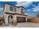 Two-story stucco home offering an arched entrance, a two car garage, and a concrete driveway at 7530 Brisa Del Mar Ave, Las Vegas, NV 89179