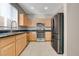 Modern kitchen features stainless steel appliances, granite countertops, and wood cabinets at 7530 Brisa Del Mar Ave, Las Vegas, NV 89179