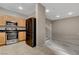 Functional kitchen offers stainless steel appliances, wood cabinetry, and easy access to the adjoining rooms at 7530 Brisa Del Mar Ave, Las Vegas, NV 89179