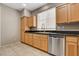 Well-lit kitchen features stainless steel appliances, wood cabinetry, and a view from a bright window at 7530 Brisa Del Mar Ave, Las Vegas, NV 89179