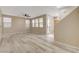 Spacious living room with wood-style flooring and many bright windows creates an inviting atmosphere at 7530 Brisa Del Mar Ave, Las Vegas, NV 89179