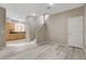 Inviting living room showcases wood-style flooring, staircase, and a seamless flow into the adjacent kitchen at 7530 Brisa Del Mar Ave, Las Vegas, NV 89179