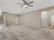 Open living area with light wood floors, two doors, a ceiling fan, and neutral paint at 7530 Brisa Del Mar Ave, Las Vegas, NV 89179
