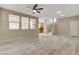 Spacious living room featuring light wood floors, a ceiling fan, and neutral paint at 7530 Brisa Del Mar Ave, Las Vegas, NV 89179