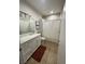 Bathroom featuring white vanity with granite countertop, framed wall art, and neutral tile flooring at 8250 N Grand Canyon Dr # 1036, Las Vegas, NV 89166