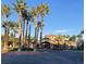 Community clubhouse surrounded by tall palm trees, featuring attractive architecture, and a welcoming entrance at 8250 N Grand Canyon Dr # 1036, Las Vegas, NV 89166