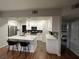 Open kitchen with white cabinets, a modern island and stainless steel appliances at 8250 N Grand Canyon Dr # 1036, Las Vegas, NV 89166