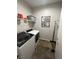 Laundry room boasts modern appliances, wire shelving, and stylish decorative wall art at 8250 N Grand Canyon Dr # 1036, Las Vegas, NV 89166
