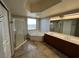 Bright bathroom featuring a soaking tub, glass shower, double vanity, and large mirror at 8255 Las Vegas Blvd # 711, Las Vegas, NV 89123