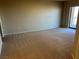 Large bedroom with neutral carpet, beige walls, and sliding glass door leading to a balcony at 8255 Las Vegas Blvd # 711, Las Vegas, NV 89123