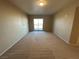 Neutral carpeted bedroom with beige walls and a sliding glass door leading to a balcony at 8255 Las Vegas Blvd # 711, Las Vegas, NV 89123