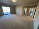 Spacious bedroom with neutral carpet, a balcony, and doorways leading to other rooms at 8255 Las Vegas Blvd # 711, Las Vegas, NV 89123