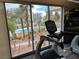Gym treadmill overlooking the pool and palm trees outside at 8255 Las Vegas Blvd # 711, Las Vegas, NV 89123