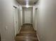 Hallway with hardwood floors and neutral color walls leading to multiple rooms at 8255 Las Vegas Blvd # 711, Las Vegas, NV 89123