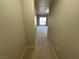 Carpeted hallway leading to a room with a sliding glass door and balcony in the distance at 8255 Las Vegas Blvd # 711, Las Vegas, NV 89123