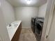 Laundry room equipped with sink, counter space, and front loading washer/dryer at 8255 Las Vegas Blvd # 711, Las Vegas, NV 89123