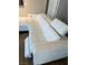 Close-up of a modern white sectional sofa with adjustable headrests and a view of a nearby door at 8255 Las Vegas Blvd # 711, Las Vegas, NV 89123