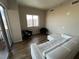 Neutral color walls with hardwood floors leading to a window with city views and seating area at 8255 Las Vegas Blvd # 711, Las Vegas, NV 89123