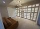 Spacious living room featuring custom built-in shelving with glass doors and modern lighting at 8255 Las Vegas Blvd # 711, Las Vegas, NV 89123