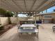 This outdoor kitchen features a built-in grill, stainless steel appliances, and a shaded dining area with seating at 8255 Las Vegas Blvd # 711, Las Vegas, NV 89123
