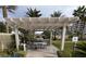 Outdoor kitchen with a built-in BBQ grill, dining area, mature palms, and ample seating in this tranquil neighborhood at 8255 Las Vegas Blvd # 711, Las Vegas, NV 89123