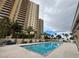 Outdoor pool featuring a lifeguard, palm trees, and high-rise views at 8255 Las Vegas Blvd # 711, Las Vegas, NV 89123