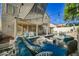 Spacious backyard featuring a covered patio, pool, and lounge area, great for entertaining at 841 Glitter Glen Ct, Las Vegas, NV 89123
