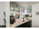 Close-up of a modern bar area with mirrored shelves and sleek countertops at 841 Glitter Glen Ct, Las Vegas, NV 89123