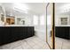 Bathroom showcasing a large vanity, soaking tub, and a spacious mirror at 841 Glitter Glen Ct, Las Vegas, NV 89123