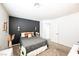 Cozy bedroom featuring a dark accent wall, soft lighting, and comfortable bedding, creating a relaxing personal space at 841 Glitter Glen Ct, Las Vegas, NV 89123