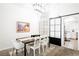 Dining area with modern table and chairs adjacent to kitchen with sliding barn door at 841 Glitter Glen Ct, Las Vegas, NV 89123
