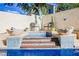 Outdoor hot tub with access steps and beautiful decorative outdoor seating and plants at 841 Glitter Glen Ct, Las Vegas, NV 89123