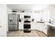 The bright kitchen features stainless steel appliances and white cabinets at 841 Glitter Glen Ct, Las Vegas, NV 89123