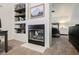 Office space with fireplace and built-in shelving, view into bedroom area with bed at 841 Glitter Glen Ct, Las Vegas, NV 89123