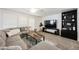 Comfortable living room with a sectional sofa, ceiling fan, and custom shelving at 841 Glitter Glen Ct, Las Vegas, NV 89123