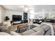 Spacious living room with large sectional sofas, a ceiling fan, and entertainment center at 841 Glitter Glen Ct, Las Vegas, NV 89123
