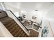 Bright and airy open-concept living space with modern furnishings and a cozy fireplace, viewed from the top of the stairs at 841 Glitter Glen Ct, Las Vegas, NV 89123