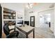 Spacious office area with built-in shelves, desk, and direct access to other rooms at 841 Glitter Glen Ct, Las Vegas, NV 89123